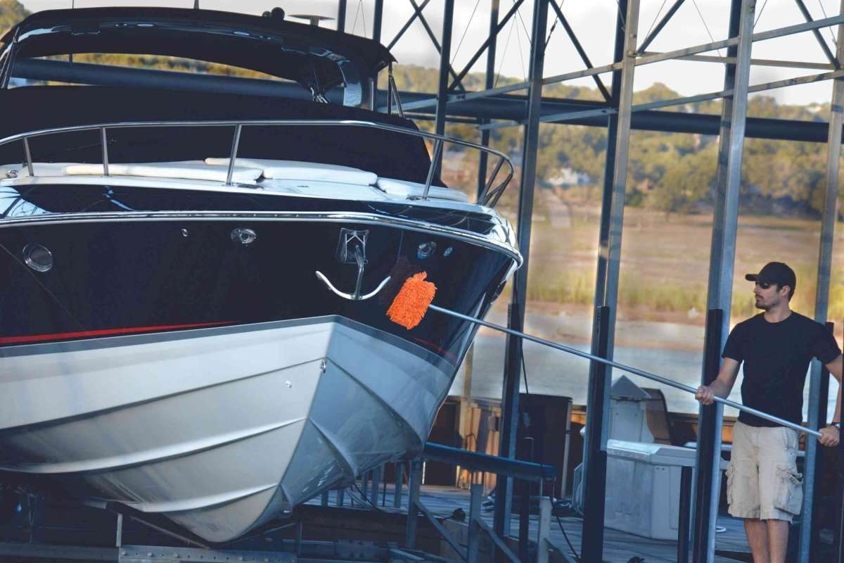 Boat cleaning at marina with man using boat wash mop aircraft, rv, boat, car